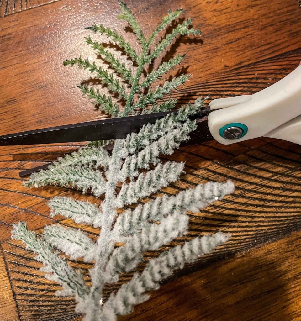 scissors cutting faux tree branch