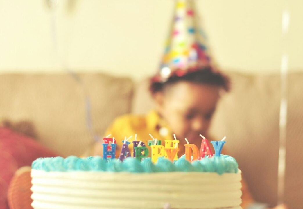 Happy birthday cake and kid with birthday hat