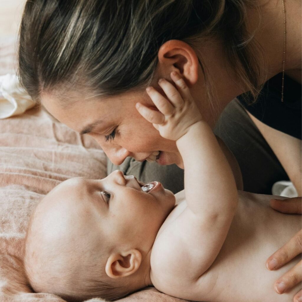 Newborn baby boy looking at mother
